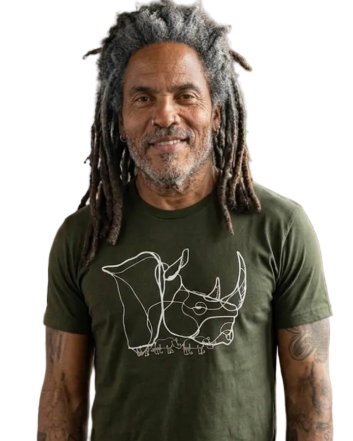 A man with gray dreadlocks stands in a music room wearing an olive green t-shirt with a cream line art graphic of a rhinoceros ( Africa ) 